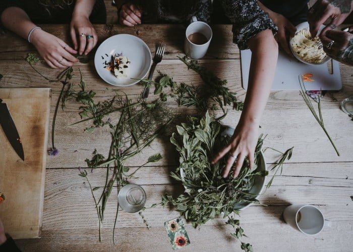 a group of people sitting around a table with food and drinks.