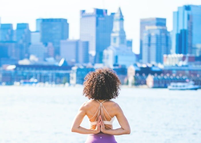 a woman standing in front of a city skyline
